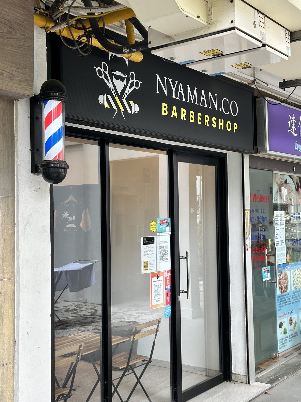 The Nyaman.co shopfront with barber pole
